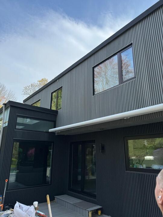 Black windows on dark vertical siding