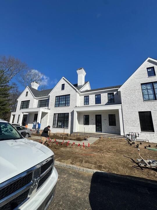 Black-framed windows on a white gabled home