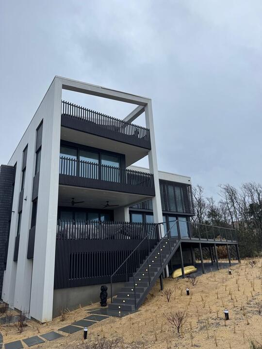 Multi-level home with balconies and sliding doors