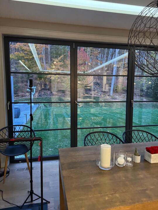 Black grid French doors and glass wall, interior view